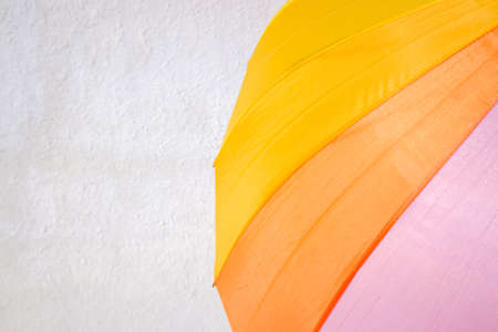 Colorful umbrella isolated on a white background wall a sunny day.の写真素材