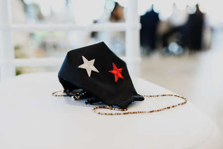 Elegant face mask, abandoned during a party, forgetting anticovid protection measures.の写真素材