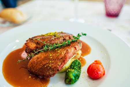 Grilled chicken fillet washed down with a herb sauce.の写真素材