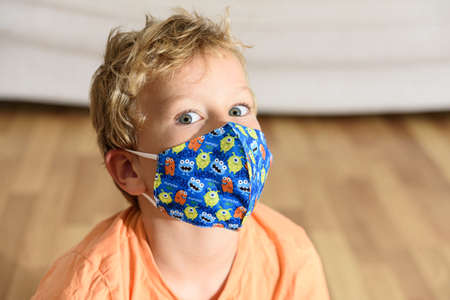 A face with an expression of astonishment in a child with a mask.
