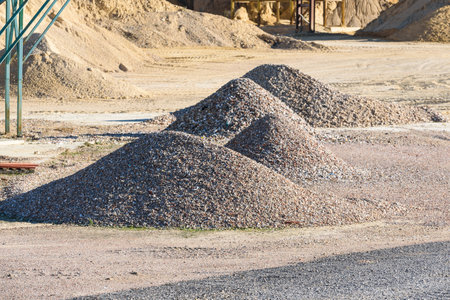 Velt conveyors and a piles of rubble in gravel quarry, crushed sand in different sizes.の写真素材