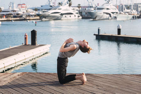 Ustrasana, Camel Pose or back bending pose, to improve back pain thanks to yoga.
