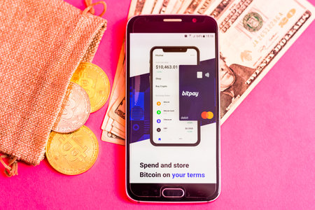 Valencia, Spain - March 2, 2021: Mobile phone with Bitpay app, to buy paying with bitcoins.のeditorial素材