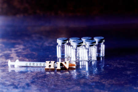 Vials and syringe with samples of the new vaccine against HIV, Human Immunodeficiency Virus.の写真素材