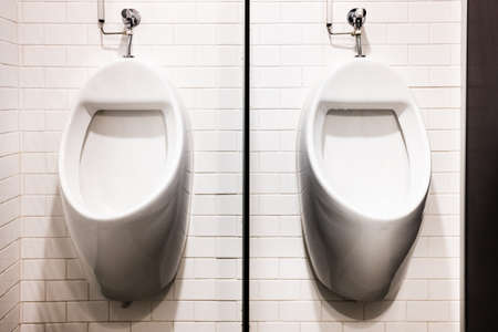 Two wall urinals in public toilets.の写真素材