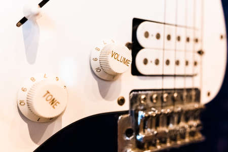Detail of an electric guitar with its volume buttons, hanging as a decoration.の写真素材