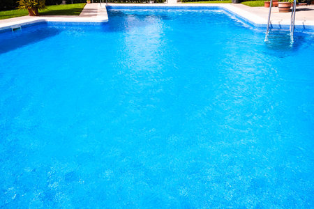 A pool with a metal ladder to access it and bathe in summer.のeditorial素材