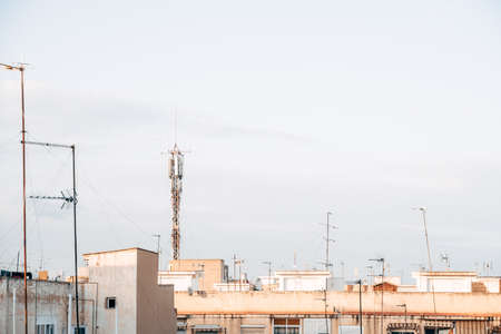 4g and 5g signal repeater tower installed in a humble working-class neighborhood of a small city.の写真素材