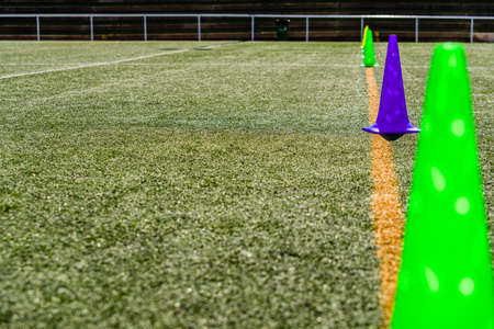 Colored cones on an pitch artificial grass sports court with copy space.の写真素材