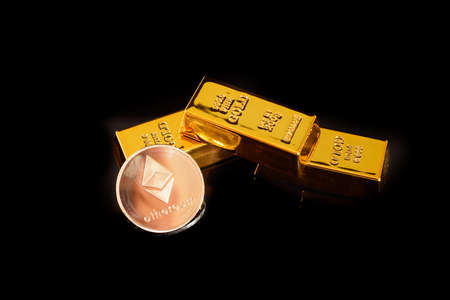 Real Ethereum token coin on some very valuable gold bars, isolated on black background.