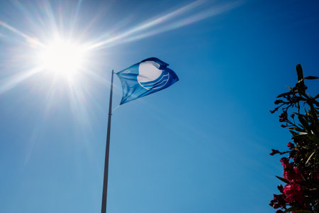 Valencia, Spain - July 6, 2021: Official blue flag to the most touristic beaches in Spain.のeditorial素材