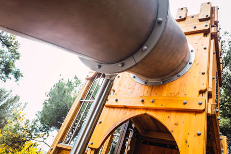 Wooden houses and forts for children with metal slidesの写真素材