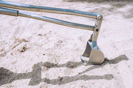 A handmade metal excavator for children and practice having fun with the sand.の写真素材