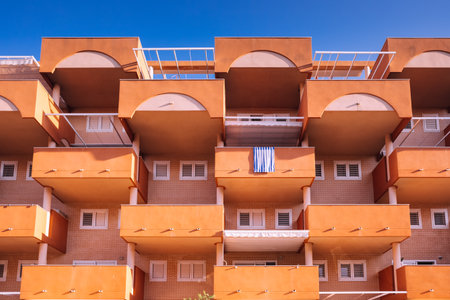 Facade of a block of holiday apartments on the beach, all with an outdoor balcony.のeditorial素材