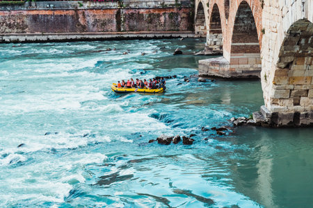 Verona, Italy - September 22, 2021: Hikers go down in an inflatable rafting boat down the river near the city of Verona.のeditorial素材
