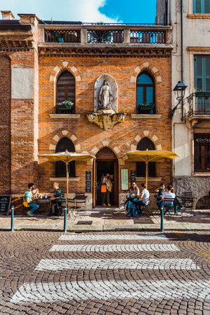 Verona, Italy - September 22, 2021: Tourists have a drink on the terrace of a traditional Italian barのeditorial素材