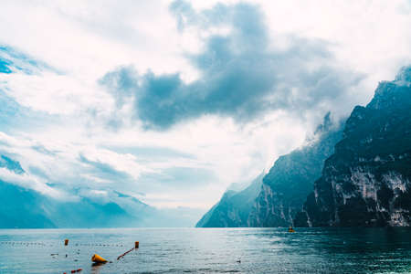 High mountains fall into a glacial lake, seen from Riva del Garda.の写真素材