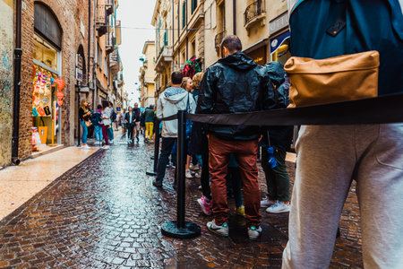 Verona, Italy - October 2, 2021: A long queue of tourists waits to enter to see Juliet and Romeo's house.のeditorial素材