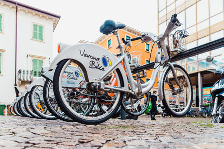 Verona, italy - october 1, 2021: Public rental electric bikes from the Verona Bike network parked on the street.のeditorial素材