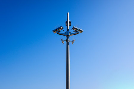 A post with several security cameras and light bulbs to control security and privacy.