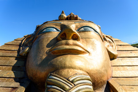 Desenzano del Garda, Italy - October 5, 2021: Sculpture of the face of an Egyptian pharaoh on his oversized sarcophagus.のeditorial素材