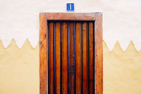 A rustic wooden door with the number 1 and copy space.の写真素材