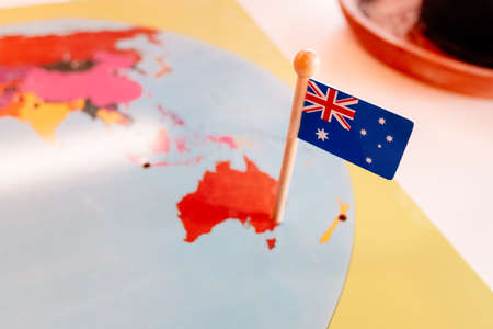 An Australian flag pinned to a Montessori map of Oceania continent in a school.の写真素材