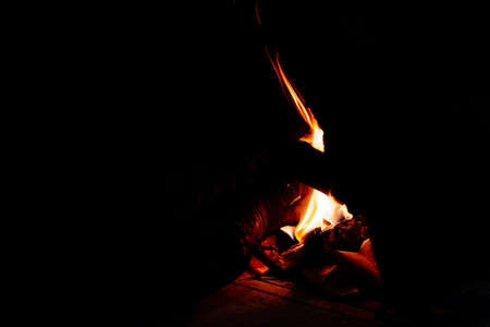A faint flame of fire illuminates the darkness that surrounds her melancholy isolated.