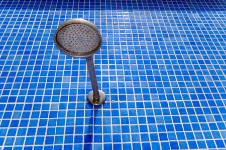 Outdoor shower head in a pool, to cool off in summer.の写真素材