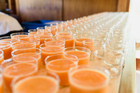 Counter of a restaurant with many glasses of healthy fruit drink.