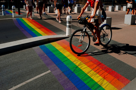 Geneva, Switzerland - August 25, 2022: Pedestrian crossings with the gay pride rainbow flag on the streets of a populous city.のeditorial素材