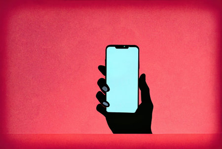 Illustration of a hand holding a smartphone, space available for text.の写真素材