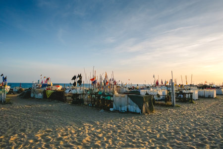 Algarve, Portugal - April 22, 2023: Fishing boats on the sandy beach, waiting for the tide.