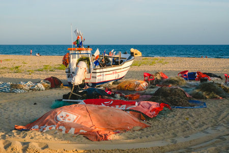 Algarve, Portugal - April 22, 2023: Fishing boats on the sandy beach, waiting for the tide.のeditorial素材