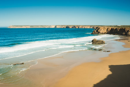 Beautiful beaches of fine sand and high, slender cliffs, one morning, in the Algarve.の写真素材