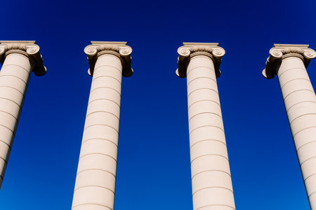 Four classical ionic columns, isolated on blue sky backgroundの写真素材