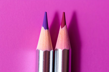 Macro of sharp pencil tip, on flat color background.の素材