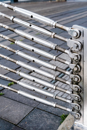 Steel stays attached to a support driven into the ground hold the steel cables of a bridge.の写真素材
