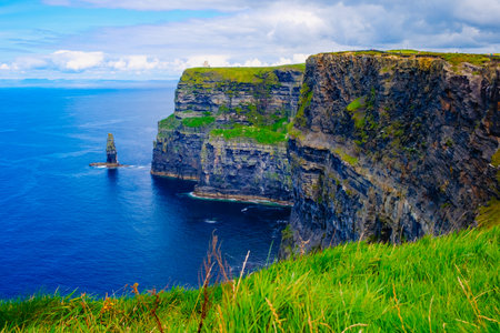 Beautiful view of the Cliffs of Moher, a calm blue sea with copy space.の写真素材