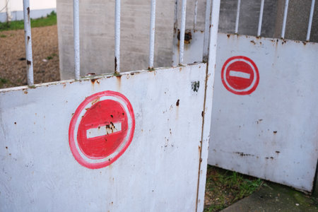 Prohibited direction signs, clumsily painted on a white private door.