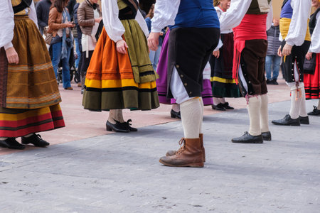 In Oviedo, Spain, a diverse group of individuals stand closely together, their body language indicating a sense of unity and togetherness. Each person is distinct yet part of a larger community, showing the diversity of humanity in a single frame.の写真素材