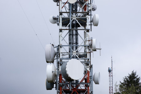 The tower stands tall with numerous antennas attached to it, serving as a hub for communication signals and data transmission. The antennas protrude in various directions, extending the reach of wireless networks and broadcasting capabilities.の写真素材