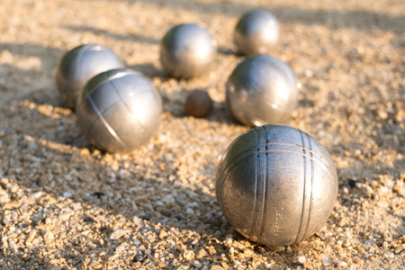 Petanque balls on the ground, detail in foreground, typical French game.の写真素材