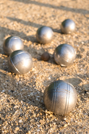 Petanque balls on the ground, detail in foreground, typical French game.の写真素材