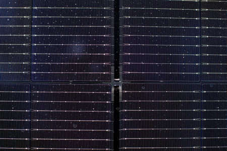 Close view of solar photovoltaic panels reveals the surface details and design. The panels show...