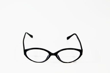 black frame oval glasses over white backgroundの写真素材