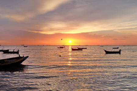Wooden boats in beautiful sunsetの写真素材
