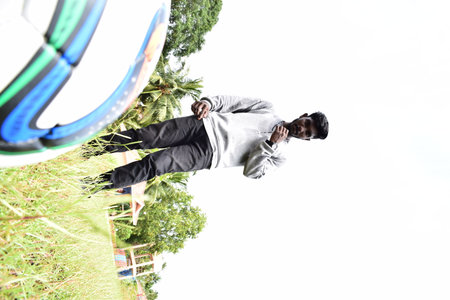 Businessman jumping with soccer ball in the park. Business concept.