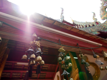 Golden Buddhist bells hangs for decoration at Wat Phra That Doi Kham (Temple of the Golden Mountain)...