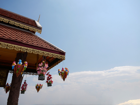 Part of traditional Thai style roof with the background of sky at Wat Phra That Doi Kham (Temple of...